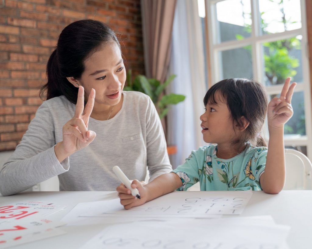 A mom doing schoolwork with her child - tips for homeschooling kindergarten