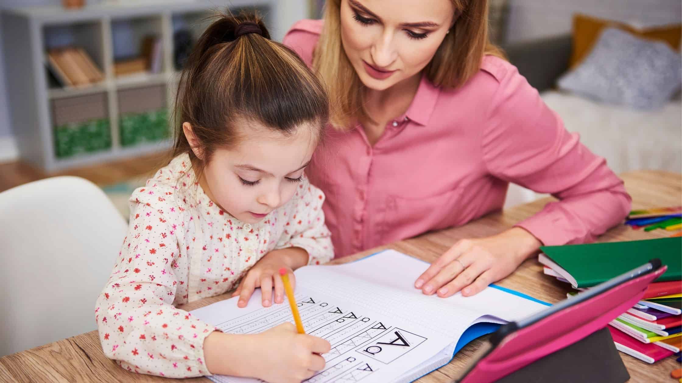 Mom working on school work with her child - Pros and Cons of Homeschooling Kindergarten: How to Decide If It's Right for You