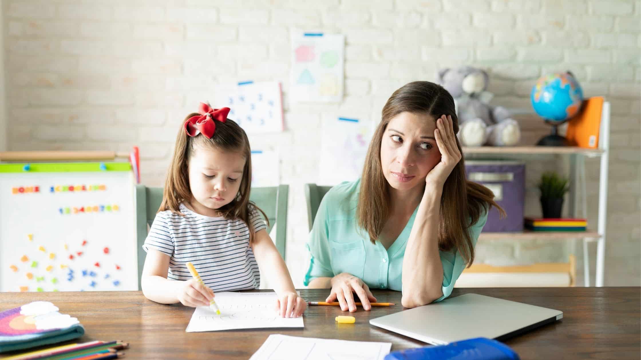 Picture of a stressed mom doing schoolwork with her child. - 20 Biggest Beginner Homeschool Mistakes You Want to Avoid