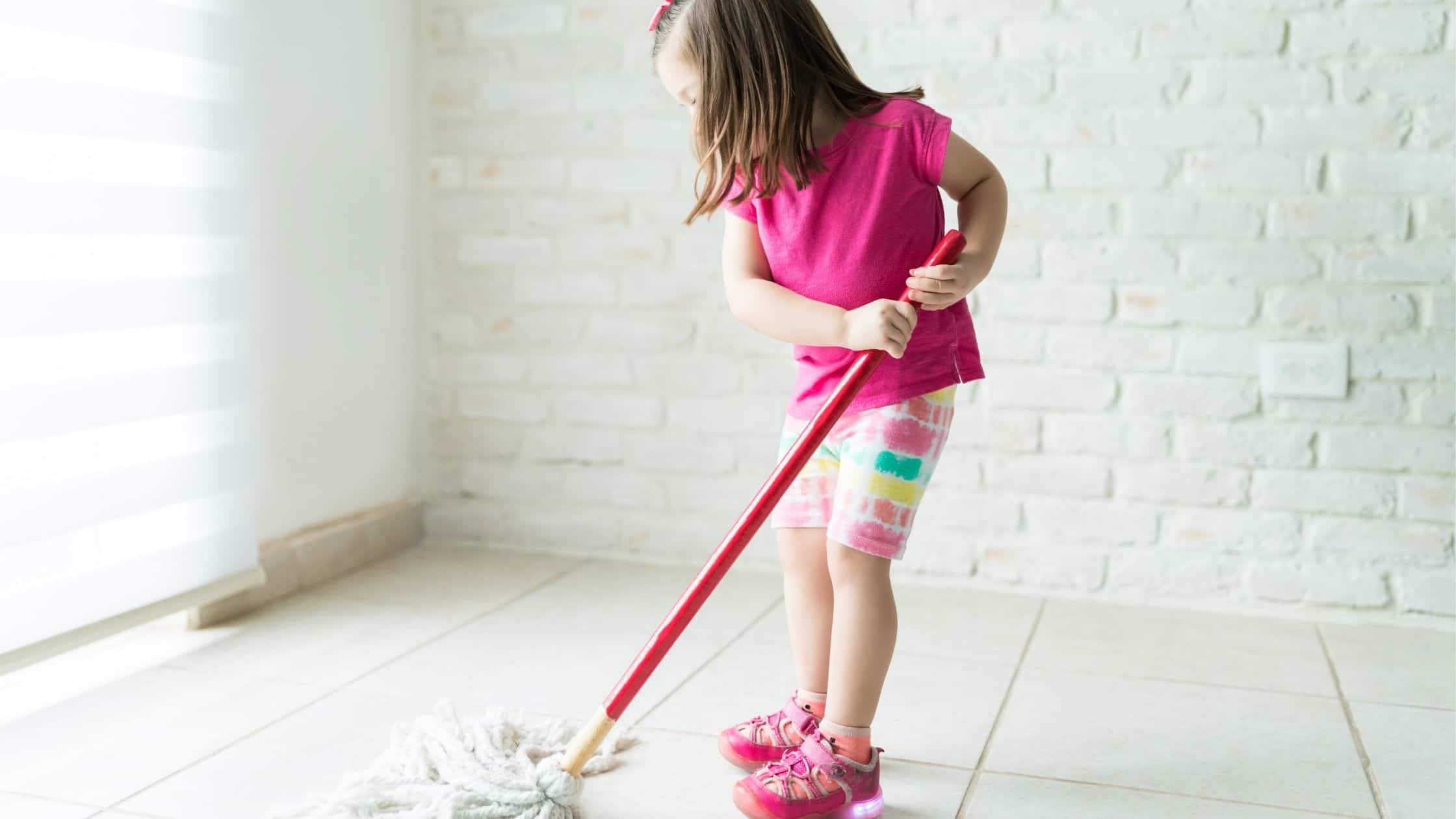 Girl mopping the floor. 9 Benefits of Using Chore Charts for Kids