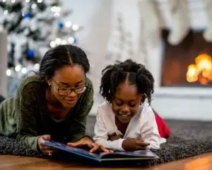 Mother and daughter reading Christmas books together