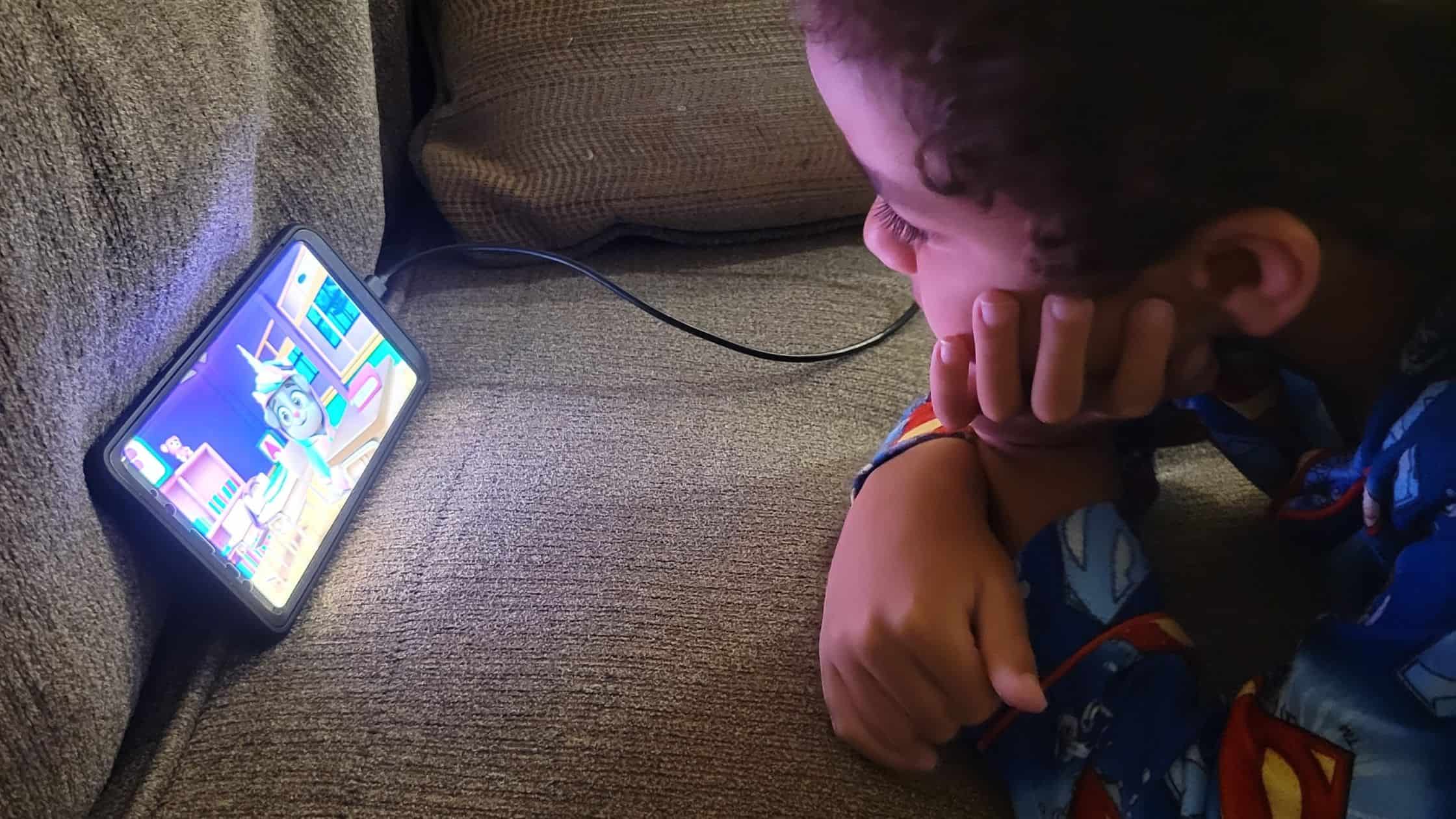 Boy watching a LuvBug learning video.